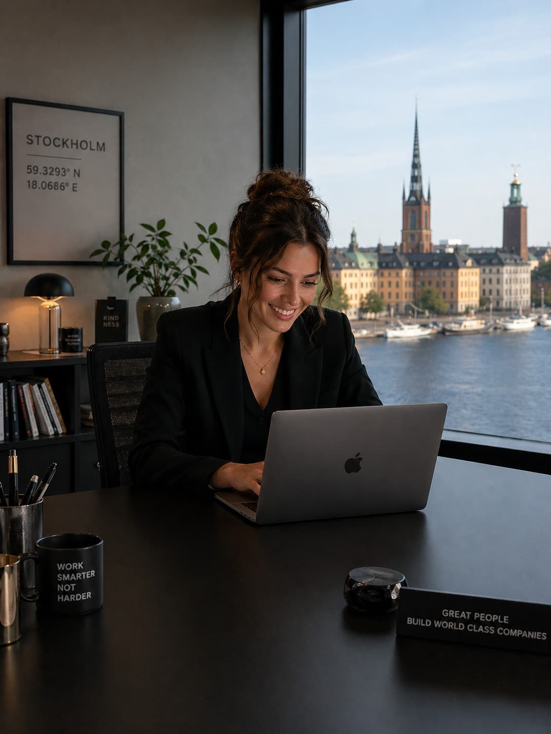 Recruiter at a laptop in a bright office with Stockholm skyline behind